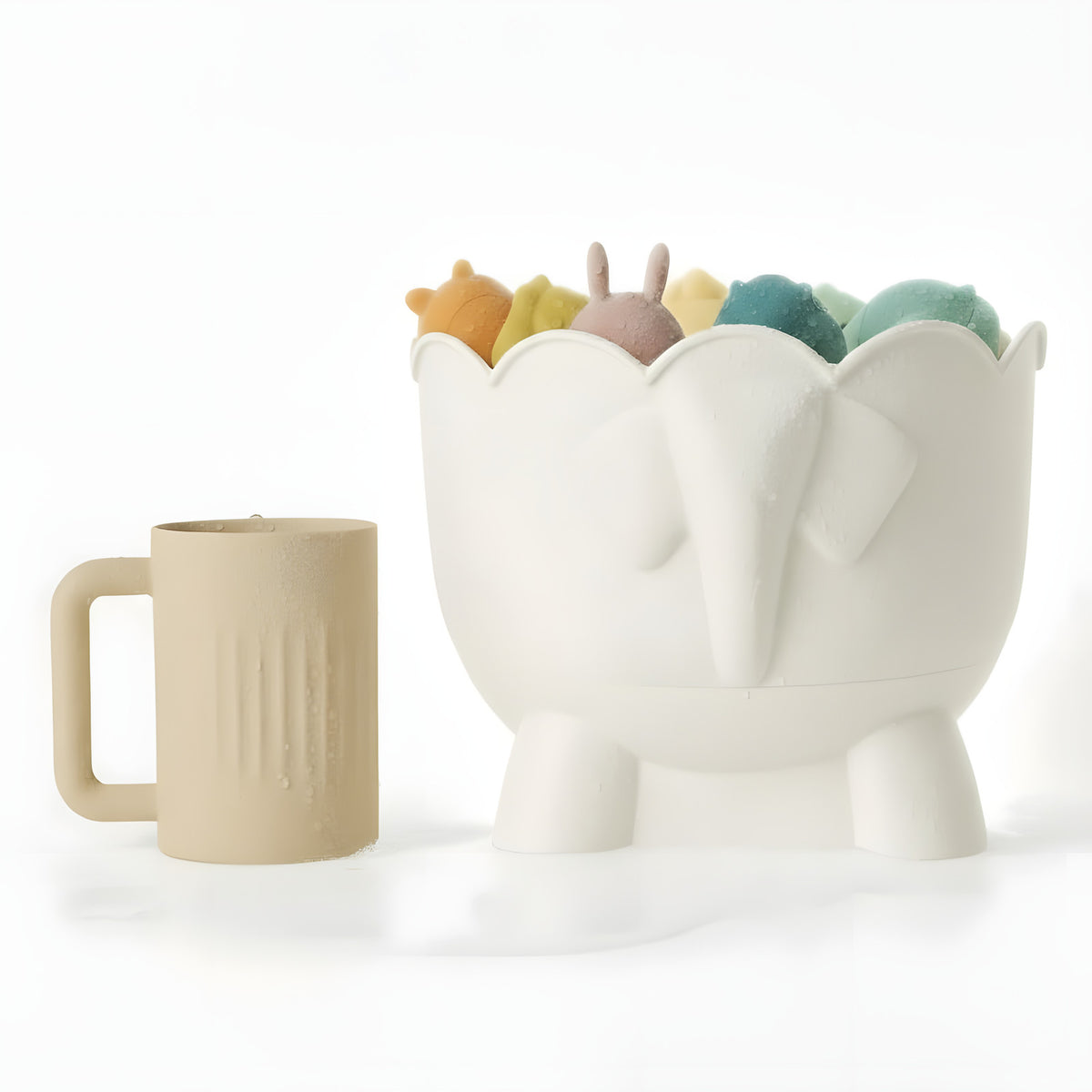 The off-white silicone rinse cup standing beside the Bath Buddy organizer, which holds a set of bath toys.