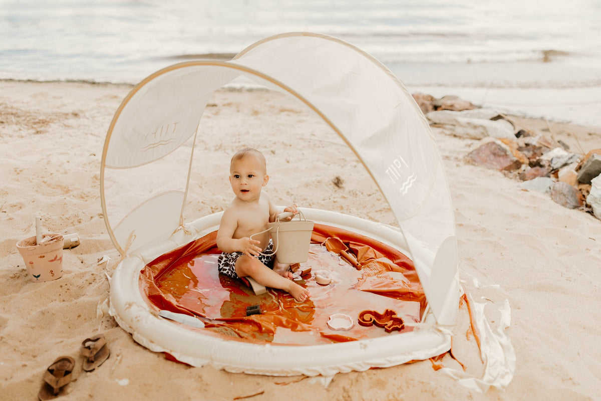 The original Tiipikids Beach Pool with Shade, canopy up, on the beach